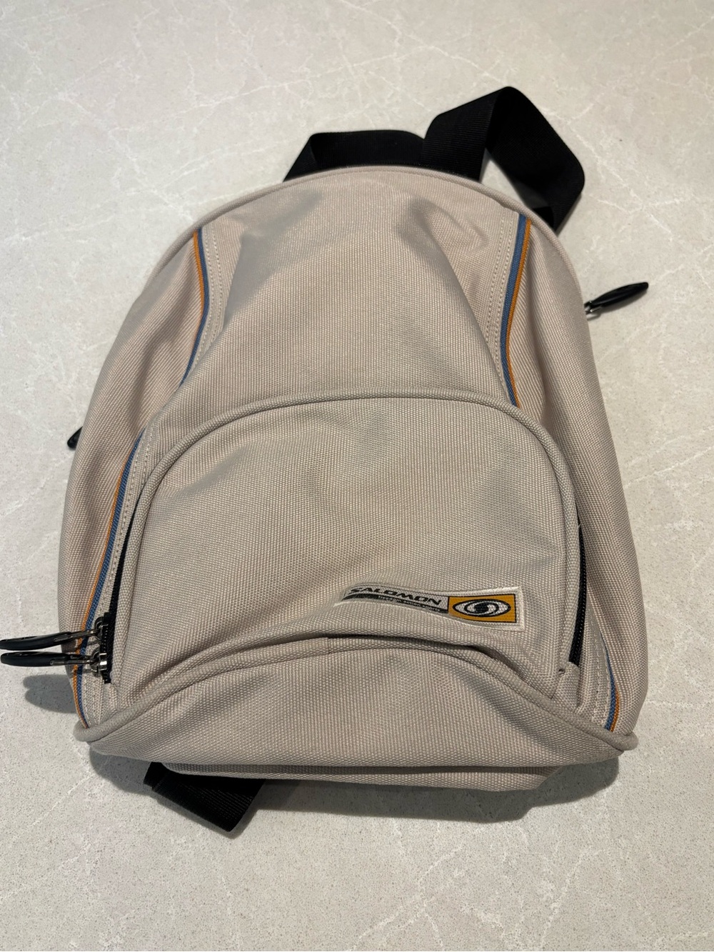 Salomon beige backpack with blue and tan trim